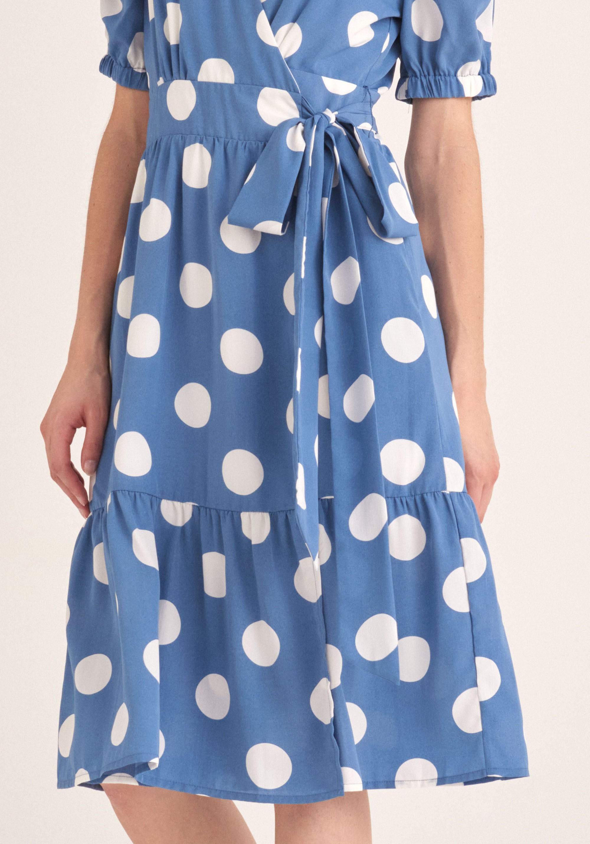 Paisie Polka Dot Midi Wrap Dress with Peplum Hem in Blue and White Close Up