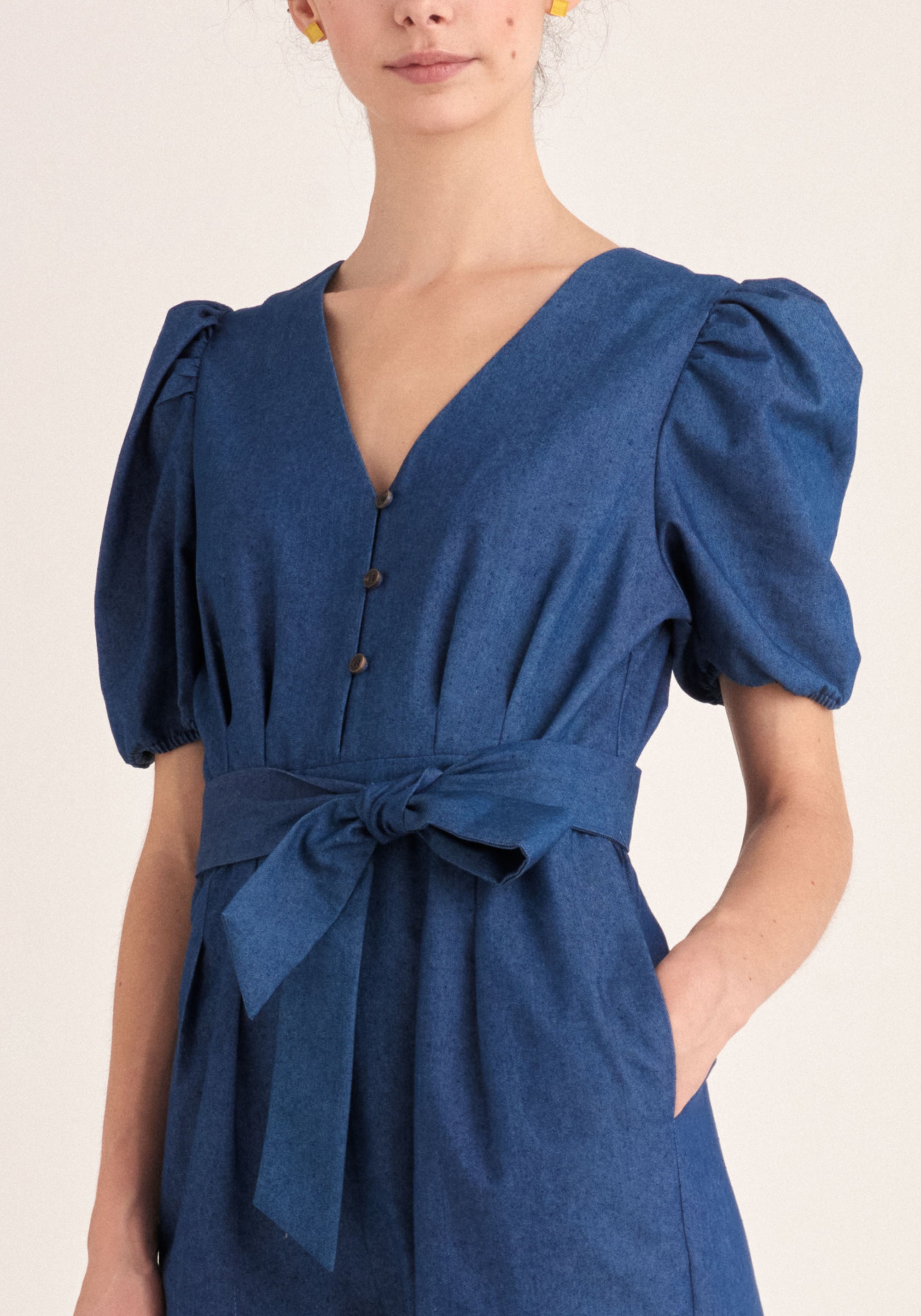 Paisie Puff Sleeve Denim Jumpsuit with Belt in Blue Close Up