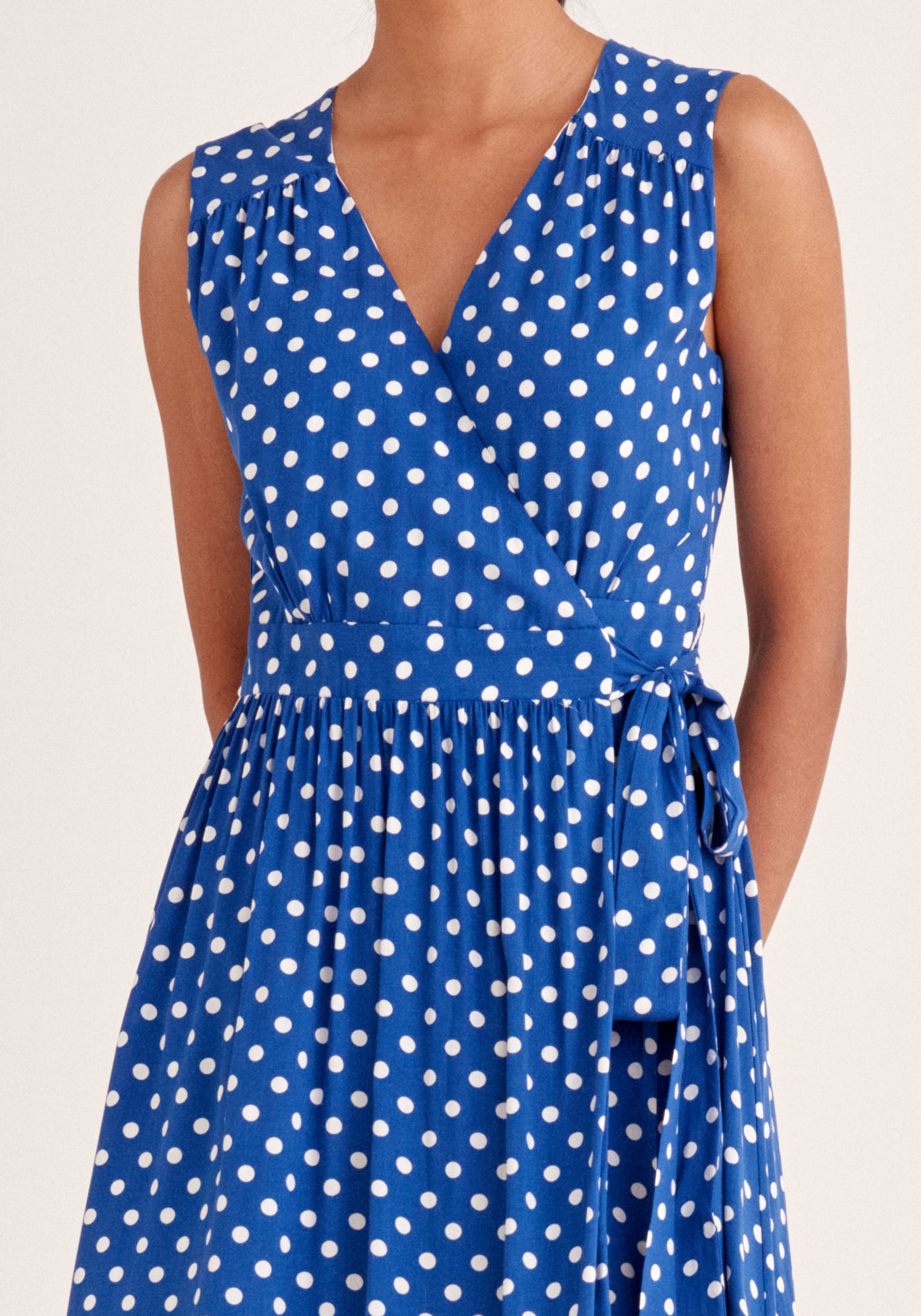 Paisie Sleeveless Polka Dot Wrap Dress in Dark Blue and White Close Up